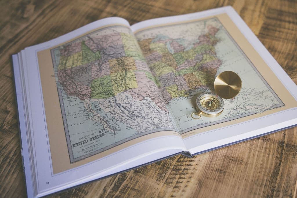 Map with a compass on top of it.