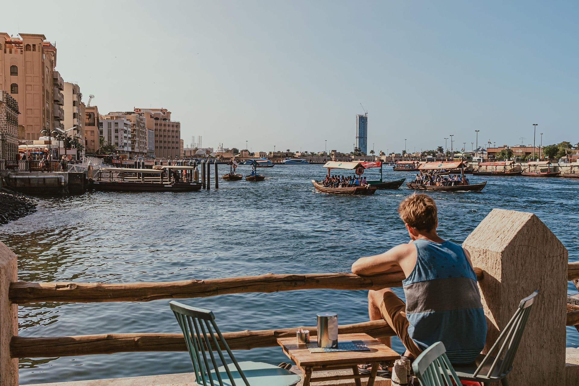 Man sitting by the water in Dubai.
